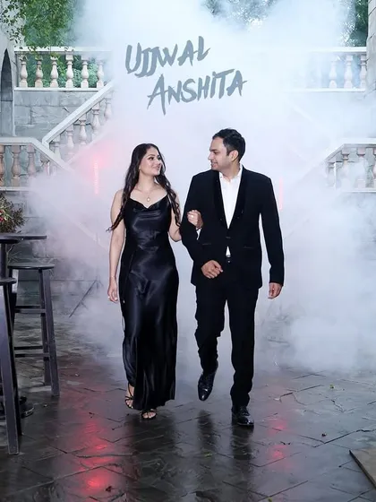 A cinematic shot of a couple walking through a smoky, classic European-style courtyard, creating a mysterious and romantic atmosphere.