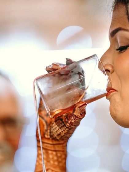 A unique Jewish wedding tradition where the bride drinks wine from a glass containing the ring her husband just placed on her finger. Capturing these cultural details is key to my work.
