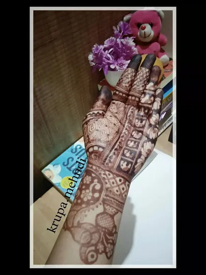 Another angle of this intricate design, showing the elephant band on the wrist and the detailed patterns on the fingers.