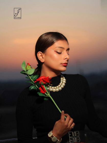 A slightly different angle of the golden hour shoot, capturing the warm glow on the model's skin and the delicate details of the rose.