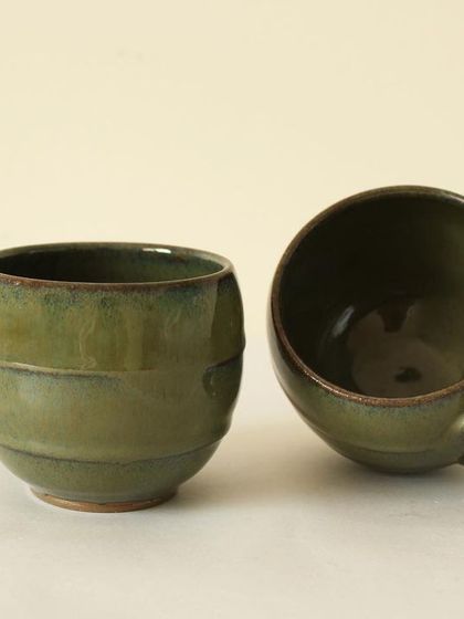 This set of two Olive Sip tea cups is perfect for a quiet moment. Their rounded, barrel-like shape feels wonderful to cup in your hands on a cool day.