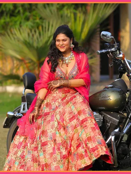 The bride posing with a Harley, a perfect blend of tradition and modern style. We love creating these unique photo opportunities.