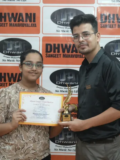 A teacher presents an award to a student for her excellent work.