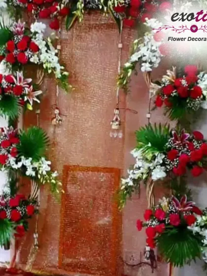 A festive backdrop using red roses, white orchids, and woven floral wreaths. This design is perfect for creating a vibrant and decorative wall for any festival.