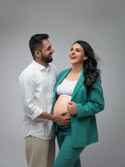 Laughter and joy between partners. This candid moment during the green pantsuit session is full of life and happiness.