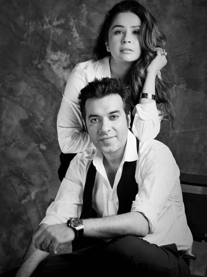 A chic black and white portrait of fashion designer Sonaakshi Raaj and restaurateur Nikhil Merani. This image captures their essence as a modern power couple.