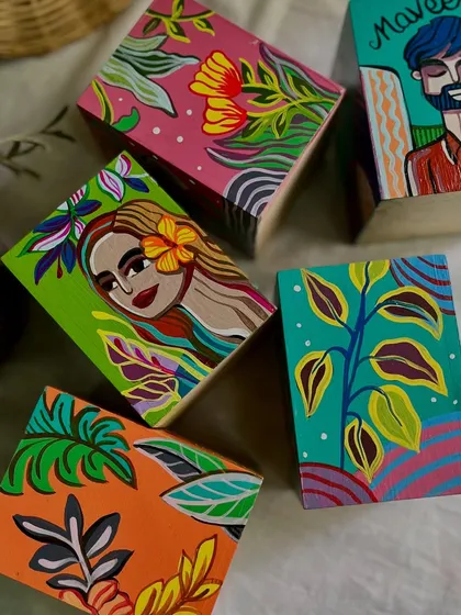 More of the custom pen stands, showing the variety of designs including portraits and tropical patterns.