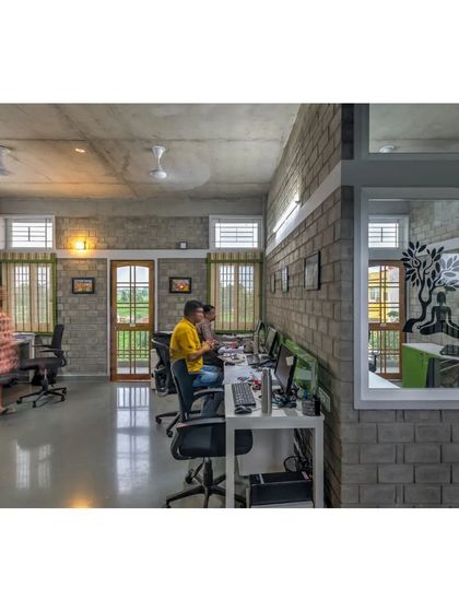 The open-plan workspace at the ASA office, filled with natural light. We designed the interiors to be collaborative and inclusive, with views out to the green landscape from every desk.
