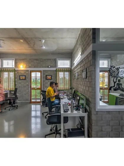 The open-plan workspace at the ASA office, filled with natural light. We designed the interiors to be collaborative and inclusive, with views out to the green landscape from every desk.