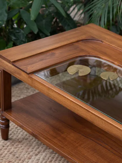 Different views of the Kulam collection, including the side table and center table. These images showcase the blend of solid teak, glass, and narrative brass accents that define this collection.
