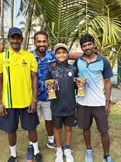 The full coaching team celebrating with Aarav Chhallani. It takes a village to raise a champion, and our team is dedicated to every player's journey.