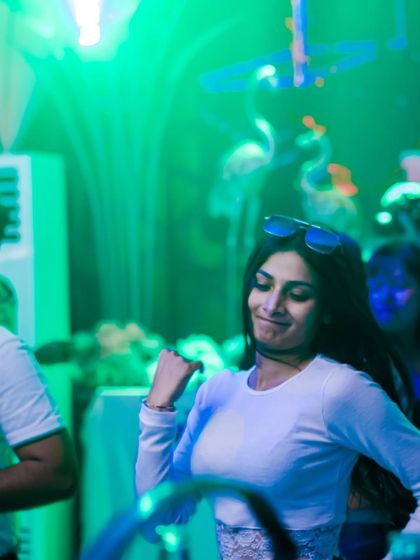 A guest dancing under the green lights. The lighting at my events is programmed to match the energy of the music.