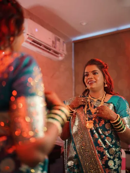 A beautiful mirror shot of the reception bride. The soft lighting highlights her glowing skin and elegant makeup.