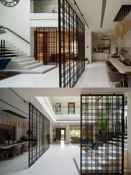 Metal grid partitions are used to define the dining and circulation spaces without closing them off, maintaining an open, airy feel throughout the ground floor.