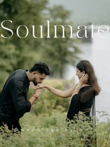 "Soulmate." A simple word for a powerful photo. A groom-to-be kisses his partner's hand in a field of green, a truly romantic pre-wedding portrait.