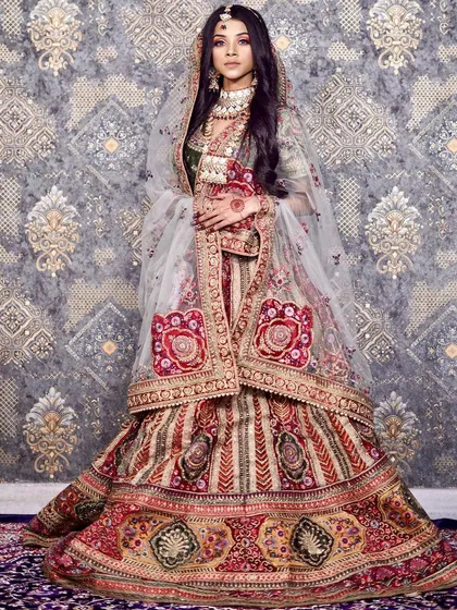 A truly regal bridal lehenga featuring rich, multi-colored embroidery. This outfit is perfect for the bride who wants a unique and majestic look, combining traditional craftsmanship with a distinctive color palette.