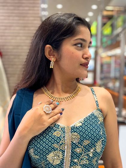 A simple and elegant gold-toned AD necklace, perfect for a subtle yet classy look.