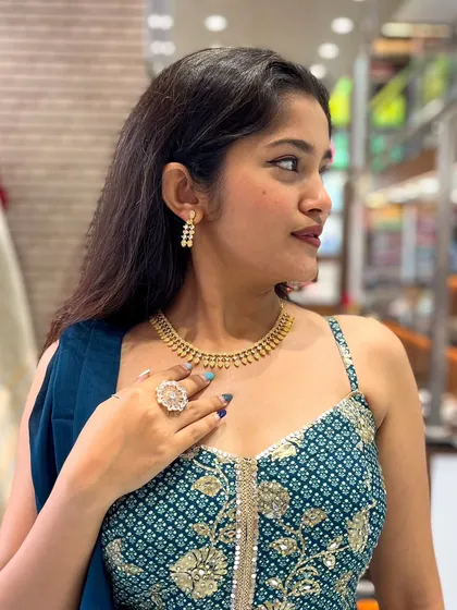 A simple and elegant gold-toned AD necklace, perfect for a subtle yet classy look.