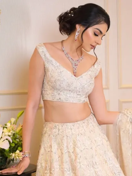 A bridal portrait of grace. The bride's delicate features are highlighted by the intricate design of the ruby and diamond necklace and matching earrings.