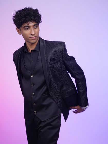 A side view of the black jacquard tuxedo, showing its sleek silhouette and modern fit.