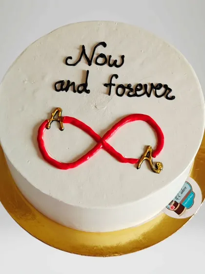 A simple and sweet anniversary cake with an infinity symbol connecting the couple's initials. It represents the idea of "Now and forever."