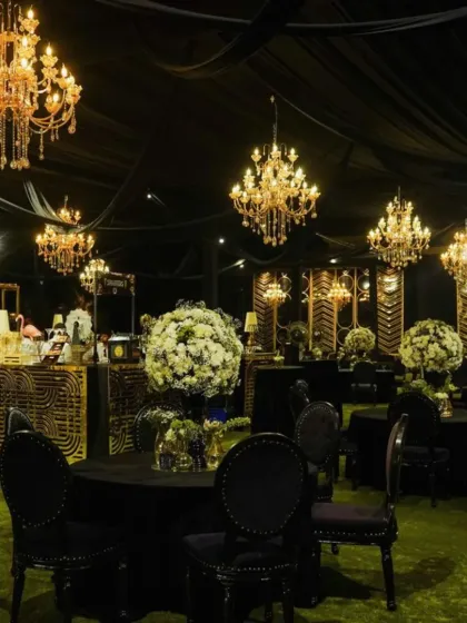 This chic cocktail party setup features a modern black and gold theme. We used black tablecloths, gold-accented furniture, and dramatic chandeliers to create a sophisticated and glamorous atmosphere, perfect for an elegant evening celebration.