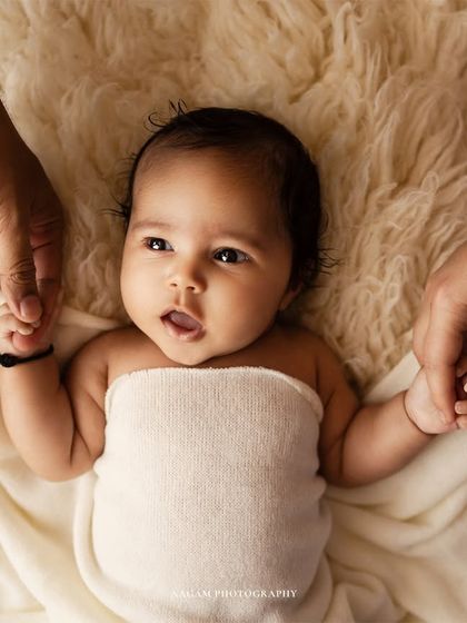 Another variation of the hands shot, capturing a slightly different expression from the baby.