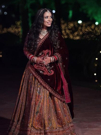 Palak's reception look was all about subtle elegance. Her multi-colored lehenga was paired with a soft makeup look and beautiful open waves.