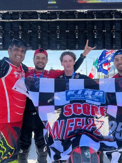 The reward for all the hard work. Our team celebrating a podium finish at the San Felipe 250, holding the checkered flag high. This is what happens when passion and preparation meet.
