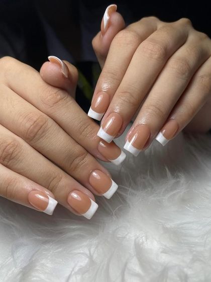 A classic French manicure on perfectly shaped square nails. Mastering this look is essential for any professional nail technician.