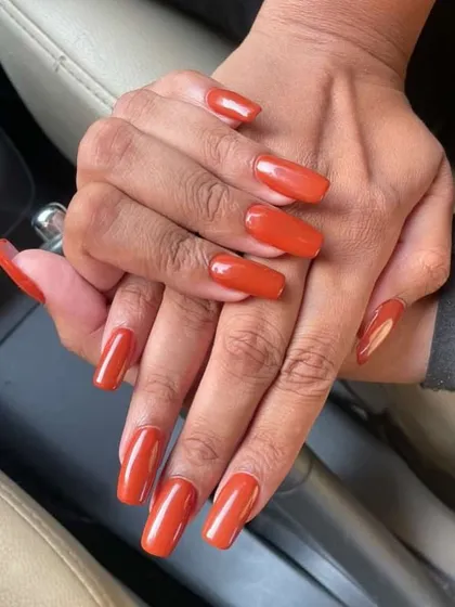 Friday night ready with these long, square-shaped nails in a stunning burnt orange color. A perfect, bold look for the weekend.