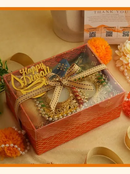 Brighten up your celebrations with our vibrant orange Navratri and Diwali hampers, filled with small treats and decorative diyas.