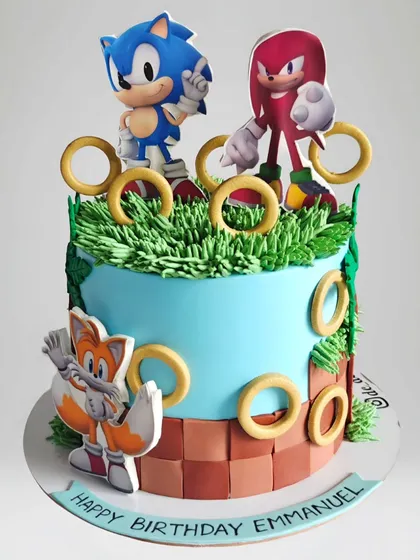 A Sonic the Hedgehog cake for an 8th birthday. This whipped cream cake features Sonic and his friends surrounded by golden rings, bringing the classic video game to life.
