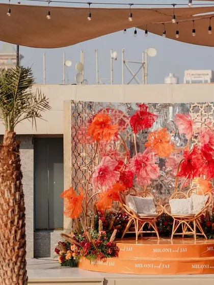 Another view of the stage, framed by a palm tree, highlighting the blend of boho and tropical vibes.
