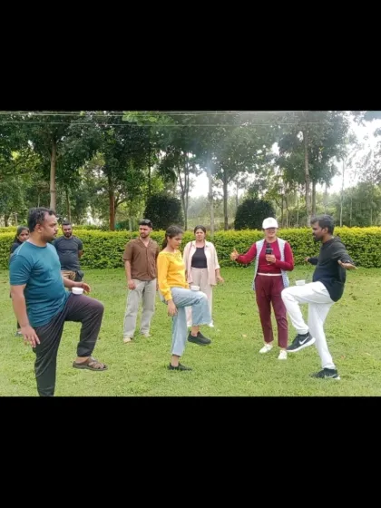 Leading a balancing game during a corporate team building event. These kinds of physical and mental challenges are a great way to get team members to work together and support each other.