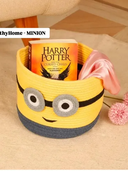 Here's the Minion storage basket in a real-life setting, showing how it can hold books and other small items to keep a child's space organized.