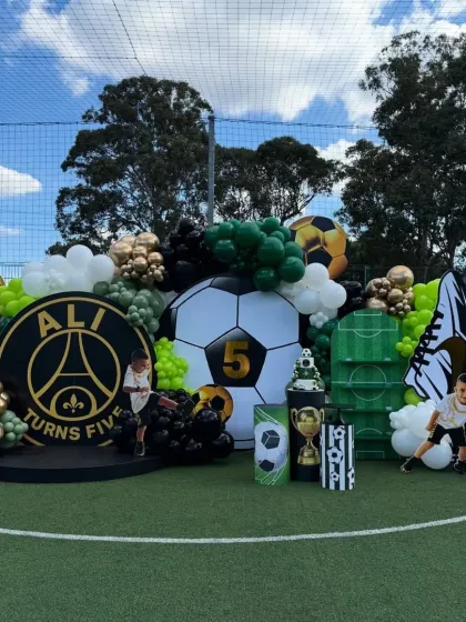 A wide shot of the entire football party stage, capturing the impressive scale and detail of the decorations.
