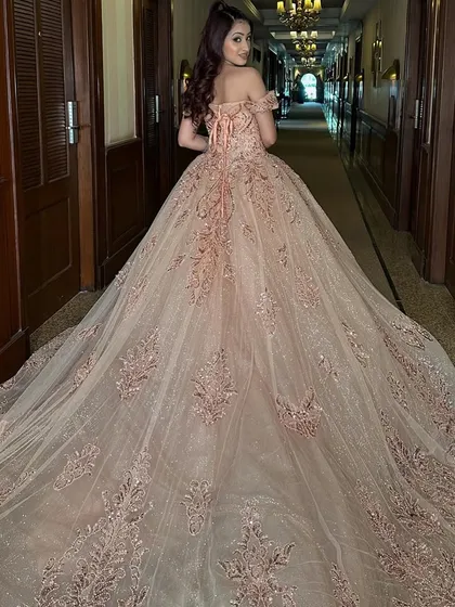 A full view of the magnificent trail on our glittery rose gold Cinderella ball gown. The intricate embroidery and sparkling sequins cover the entire length of the train, creating a truly breathtaking effect from behind.