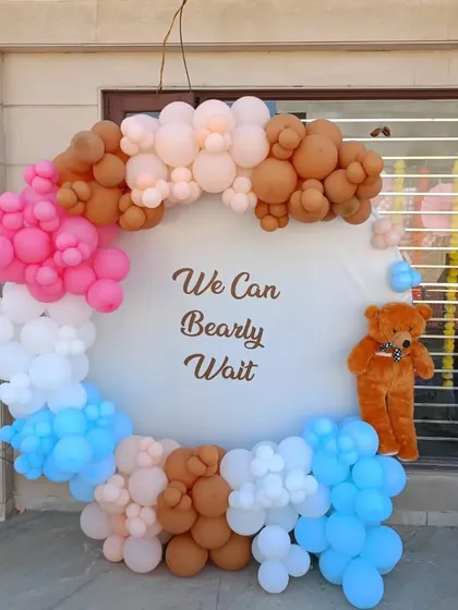 A unique take on the "We Can Bearly Wait" theme, using a colorful mix of pink, blue, brown, and white balloons. This setup is perfect for a gender reveal or a vibrant baby shower.