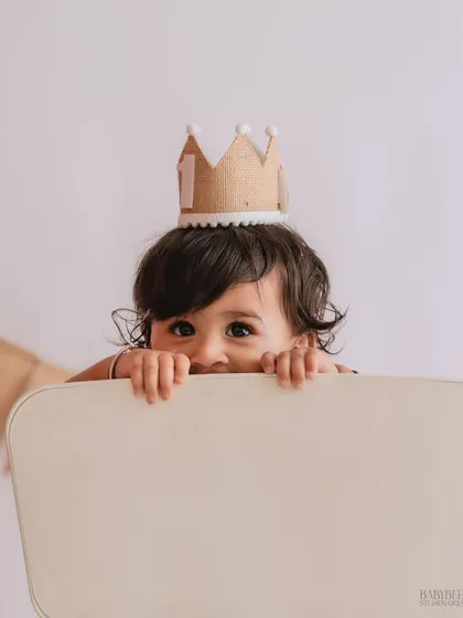 Sometimes the best moments are the unplanned ones. This playful peek-a-boo shot captures the cheeky, giggly side of childhood that we love, turning a simple moment into a precious memory.