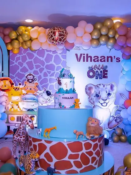 A closer look at a vibrant safari themed birthday party. I used a giraffe print backdrop, colorful balloon garlands, and adorable life-size cutouts of jungle animals like lions, monkeys, and zebras to create a fun, wild atmosphere.
