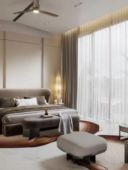 A spacious and bright master bedroom suite with a dedicated seating area by the window. Our renders capture the airy feeling of the room, the elegant furniture, and the seamless integration of a modern fireplace.