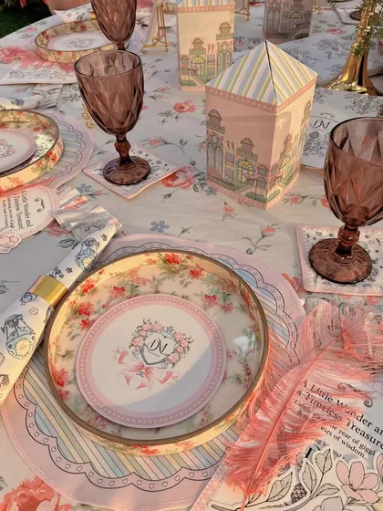 Detailed tablescape with custom-printed menus, coasters, and miniature house-shaped favor boxes.