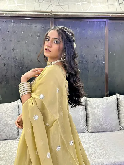 Another beautiful shot of this guest in her sage green lehenga. The makeup is soft and luminous, perfect for a wedding celebration.