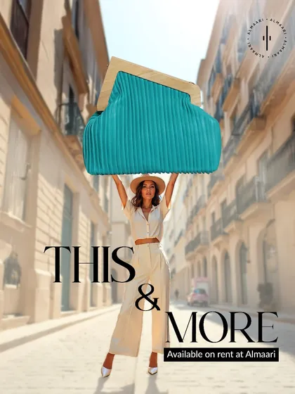 Sometimes the bag makes the outfit. This oversized turquoise pleated clutch is a perfect example. It's a bold, architectural piece that adds a pop of color and high-fashion edge to any look, whether it's western or fusion.