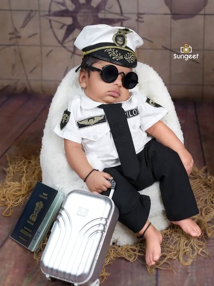 The coolest pilot on the tarmac. With sunglasses and a suitcase, this little one is the epitome of style in our popular pilot-themed newborn shoot.
