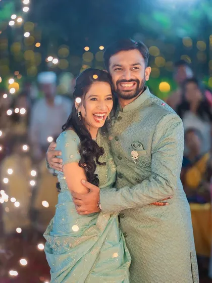 A moment of pure joy for Varad and Dr. Rutuja, surrounded by guests and sparklers. This candid shot captures the energy and excitement of the celebration.