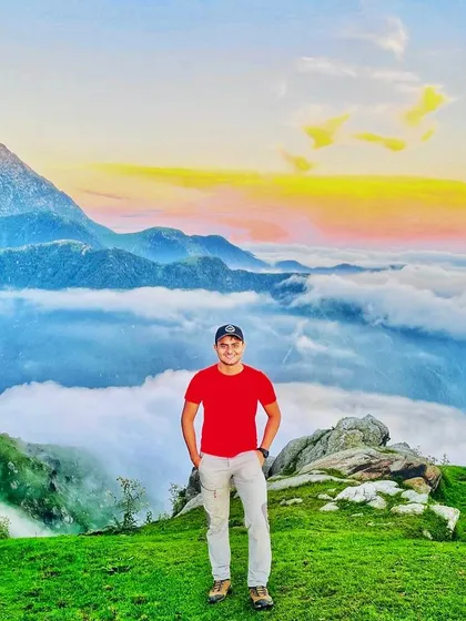 Standing on top of the world at Triund, with a sea of clouds below and the Himalayas stretching out before you.