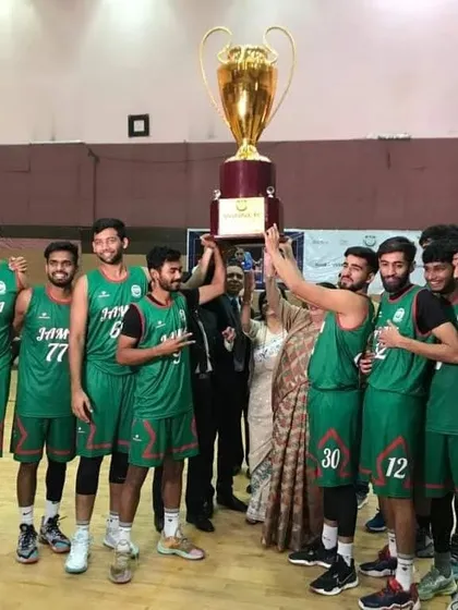 Another angle of the winning team celebrating their North Zone Inter-University Basketball title. Capturing these moments of triumph is the ultimate reward for the meticulous planning that goes into a multi-day tournament.