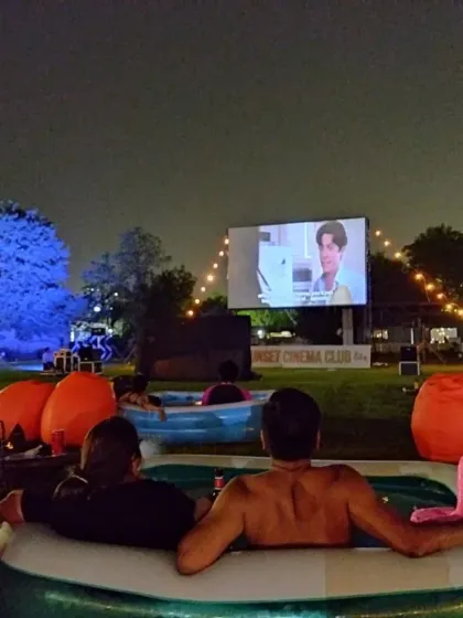 A couple enjoying their private inflatable tub at our Bathtub Cinema. It's a fun, quirky, and intimate way to experience your favorite films under the stars.